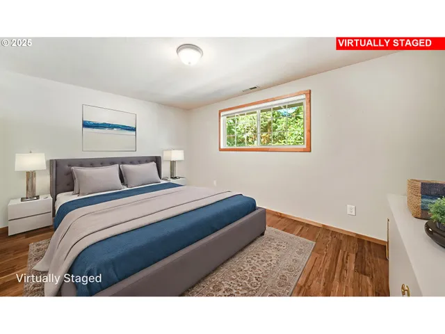 a bedroom with a bed and a painting on the wall