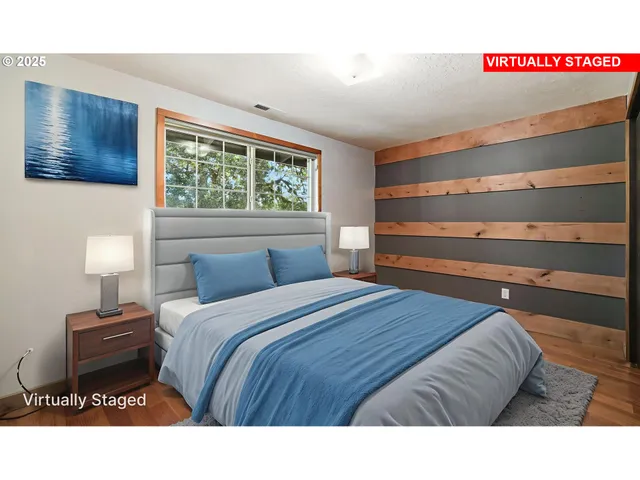 a bedroom with a bed and a night stand