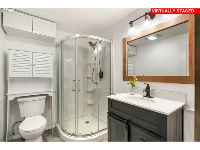 a bathroom with a sink toilet and shower