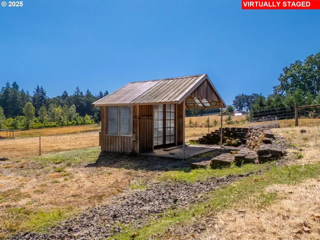 a view of a house with backyard and sitting area