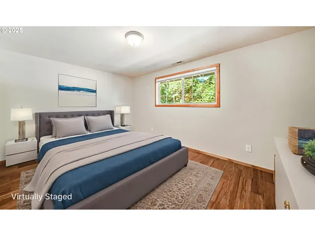 a bedroom with a bed and a painting on the wall