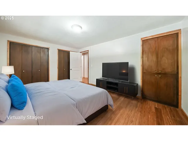 a bedroom with a bed and a flat screen tv