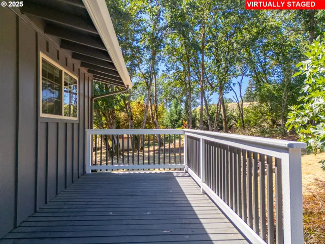 a view of balcony with wooden floor and fence