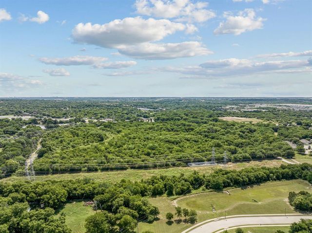 a view of a field with an ocean