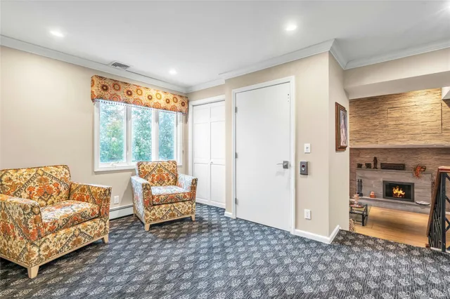 a living room with furniture and a floor to ceiling window