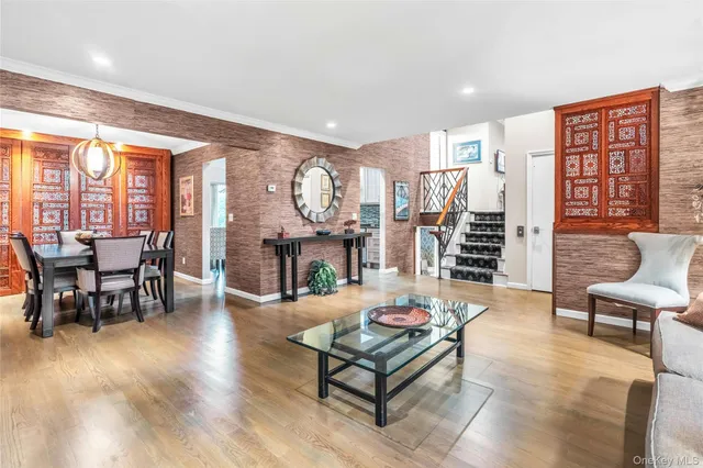 a living room with furniture and a floor to ceiling window