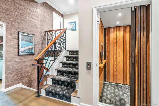 a view of entryway with wooden floor and stairs