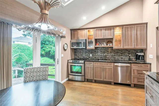 a kitchen with stainless steel appliances granite countertop a stove sink and cabinets