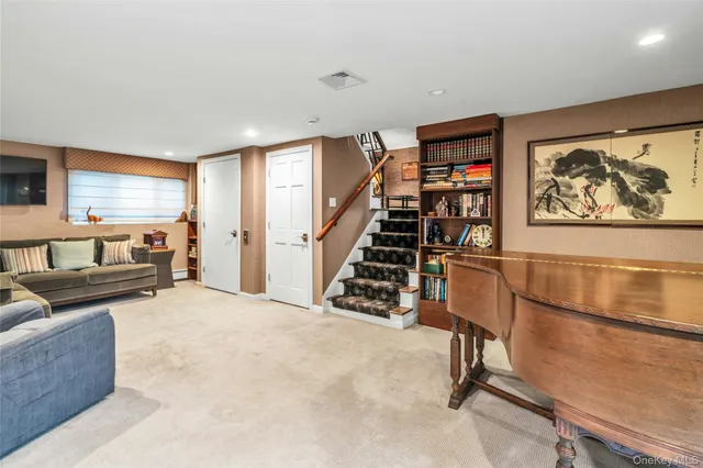 a view of a livingroom with furniture and staircase