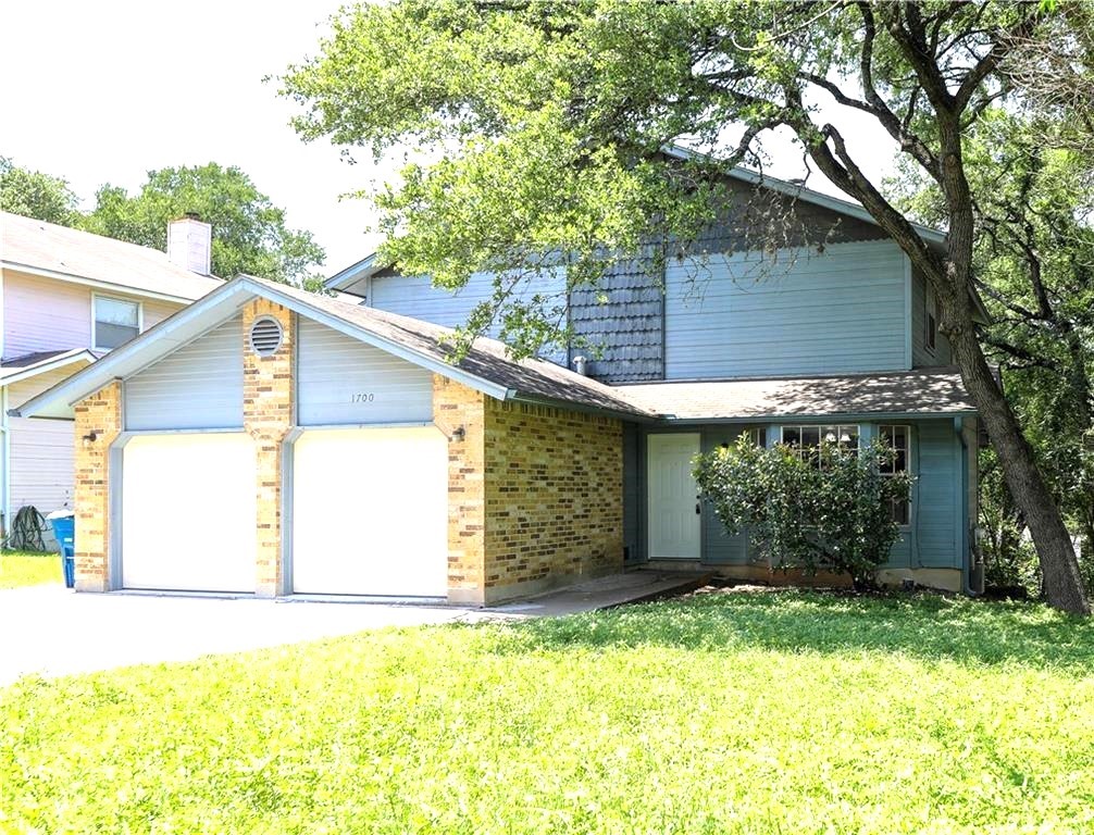 1700 Waterloo Trail, Unit B Austin, TX 78704 - Photo 1 of 1 a backyard of a house with wooden fence and large trees
