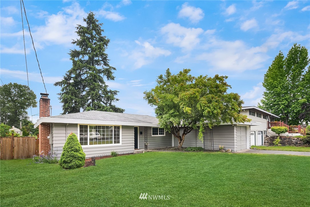1110 Olympia Avenue Northeast Renton, WA 98056 - Photo 1 of 20 a front view of a house with garden