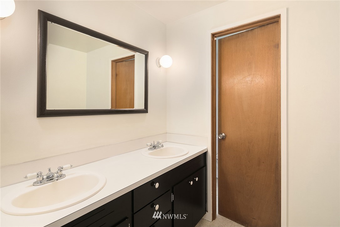 1110 Olympia Avenue Northeast Renton, WA 98056 - Photo 14 of 20 a bathroom with a sink and a mirror