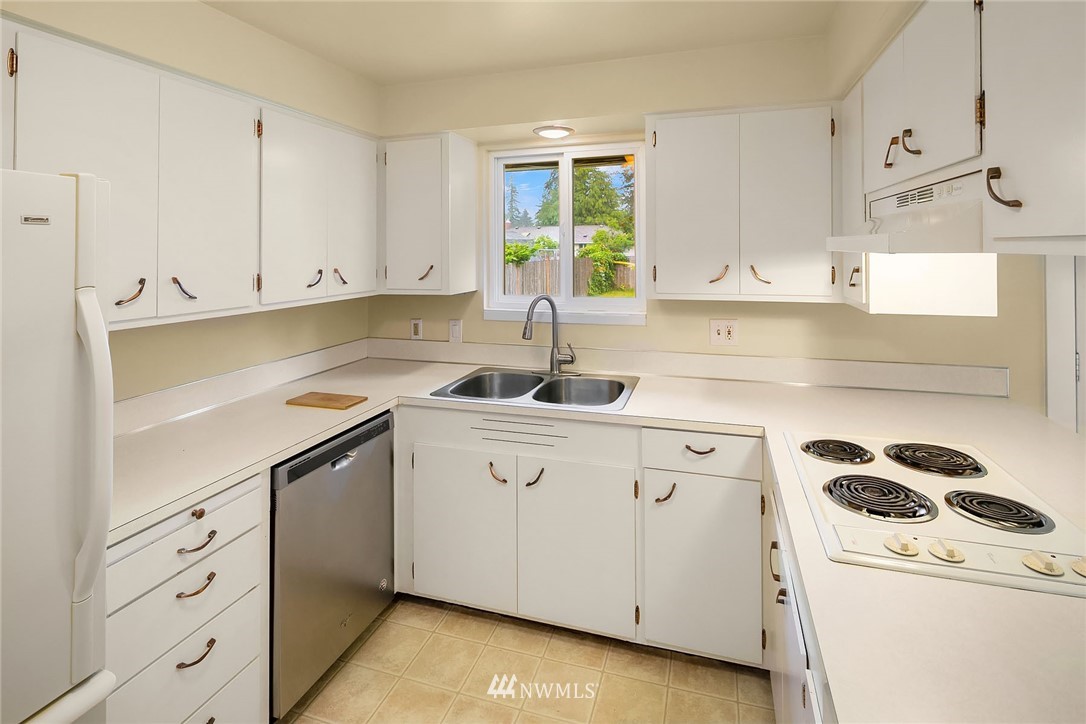 1110 Olympia Avenue Northeast Renton, WA 98056 - Photo 6 of 20 a kitchen with cabinets appliances a sink and a window
