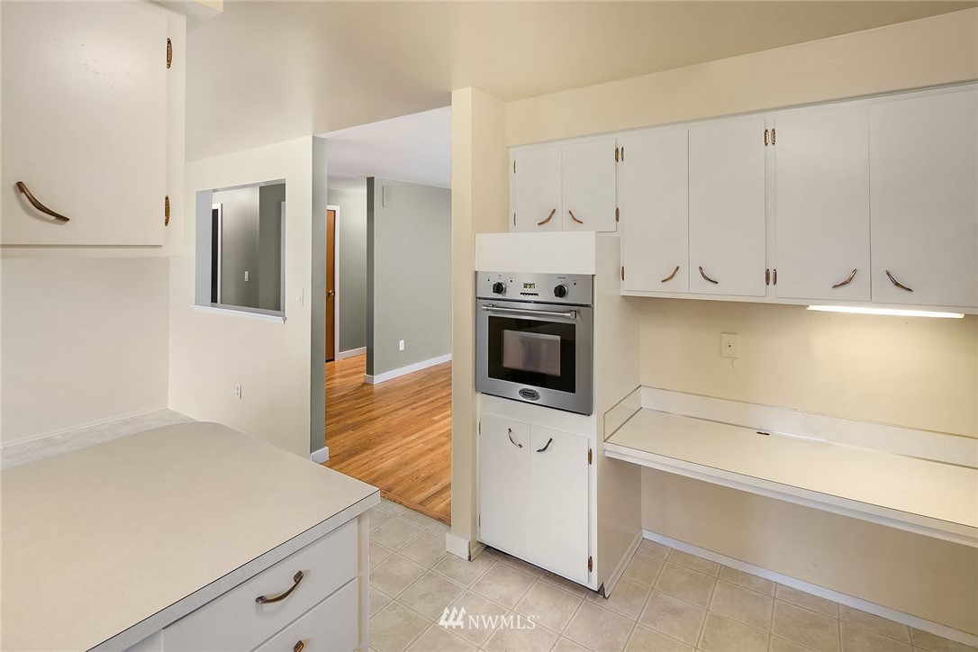 1110 Olympia Avenue Northeast Renton, WA 98056 - Photo 8 of 20 a kitchen with white cabinets and appliances