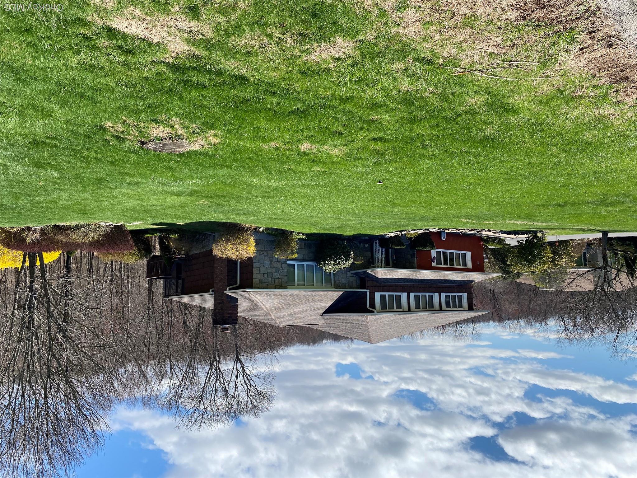 The property features a multi-level design with a shingled roof and a prominent chimney