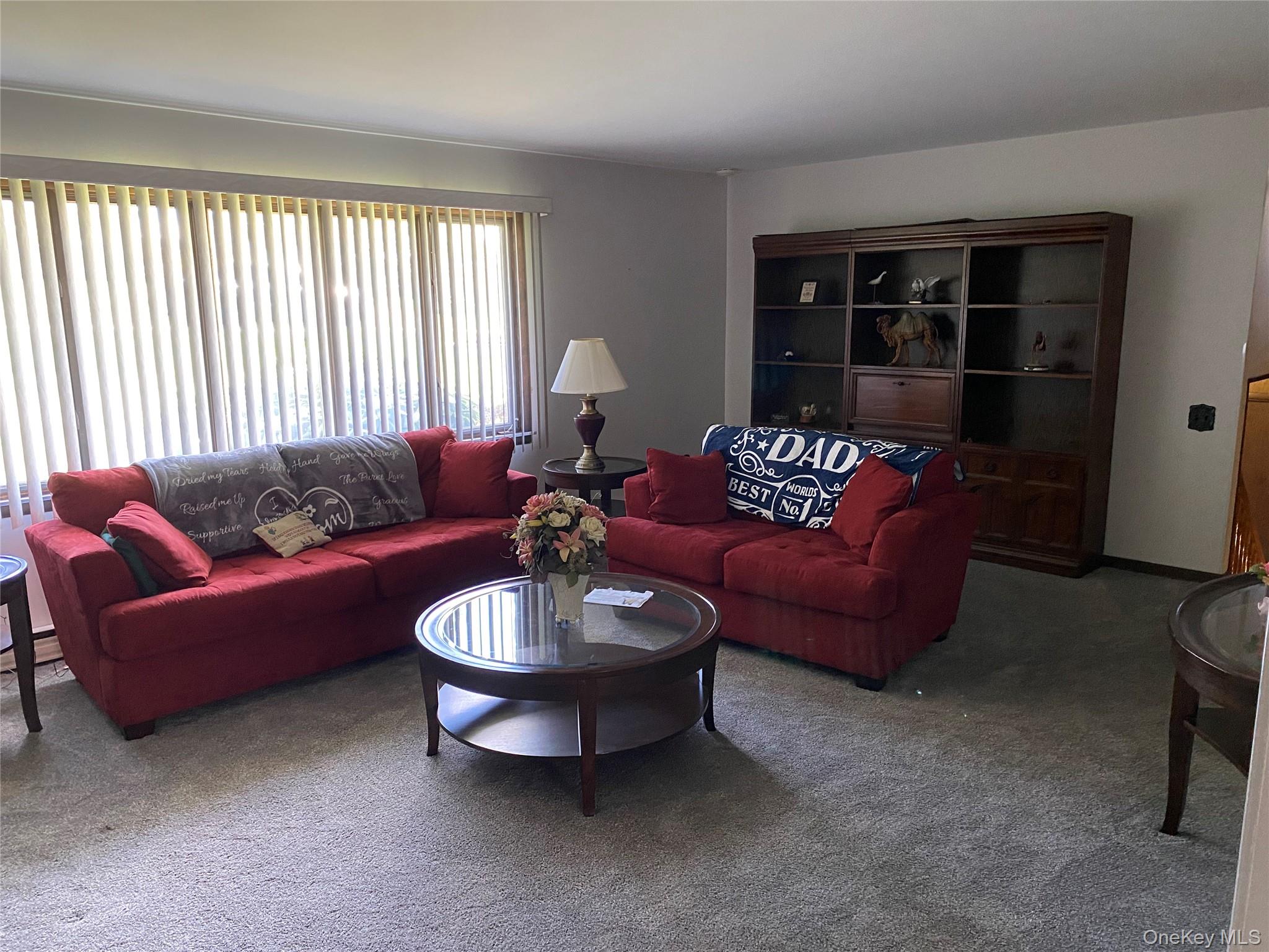 23 Colton Road Mahopac, NY 10541 - Photo 16 of 35 Living area with carpeted flooring, large windows, and a built-in wooden shelving unit