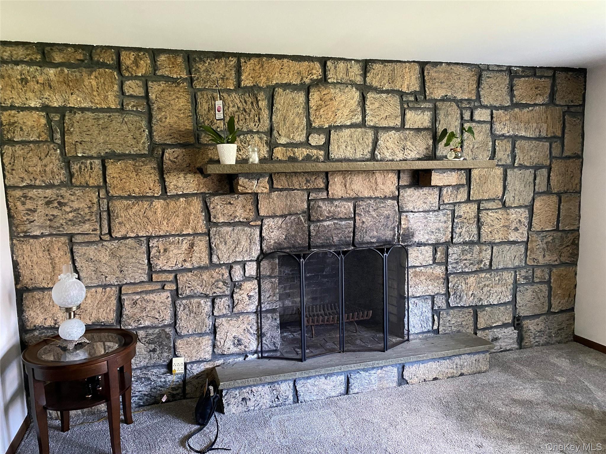 23 Colton Road Mahopac, NY 10541 - Photo 17 of 35 Living room featuring a floor-to-ceiling natural stone fireplace with a stone mantel and hearth