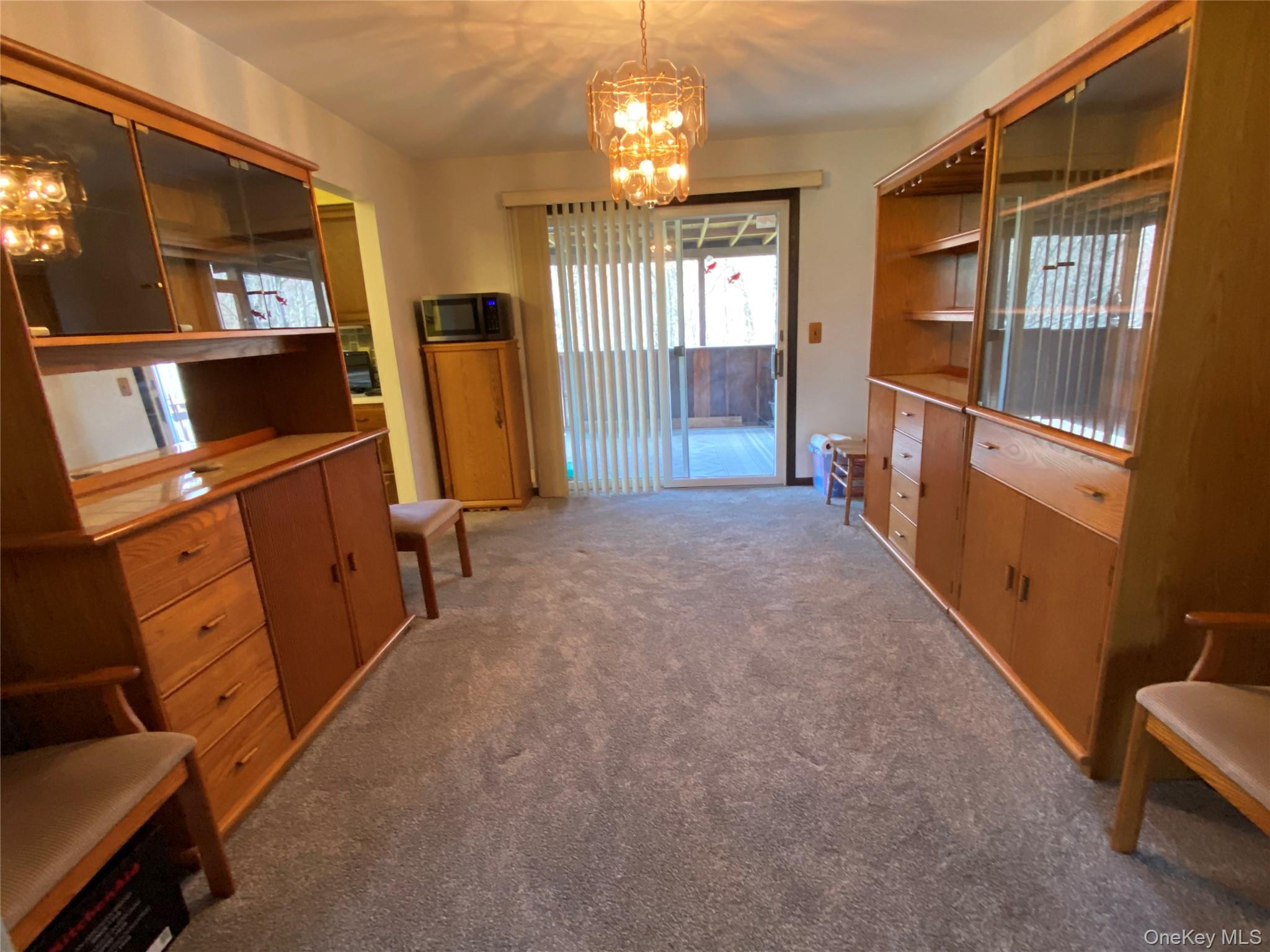 23 Colton Road Mahopac, NY 10541 - Photo 20 of 35 The Dining Room features wall-to-wall carpeting and a glass sliding door leading to the Screened in Porch