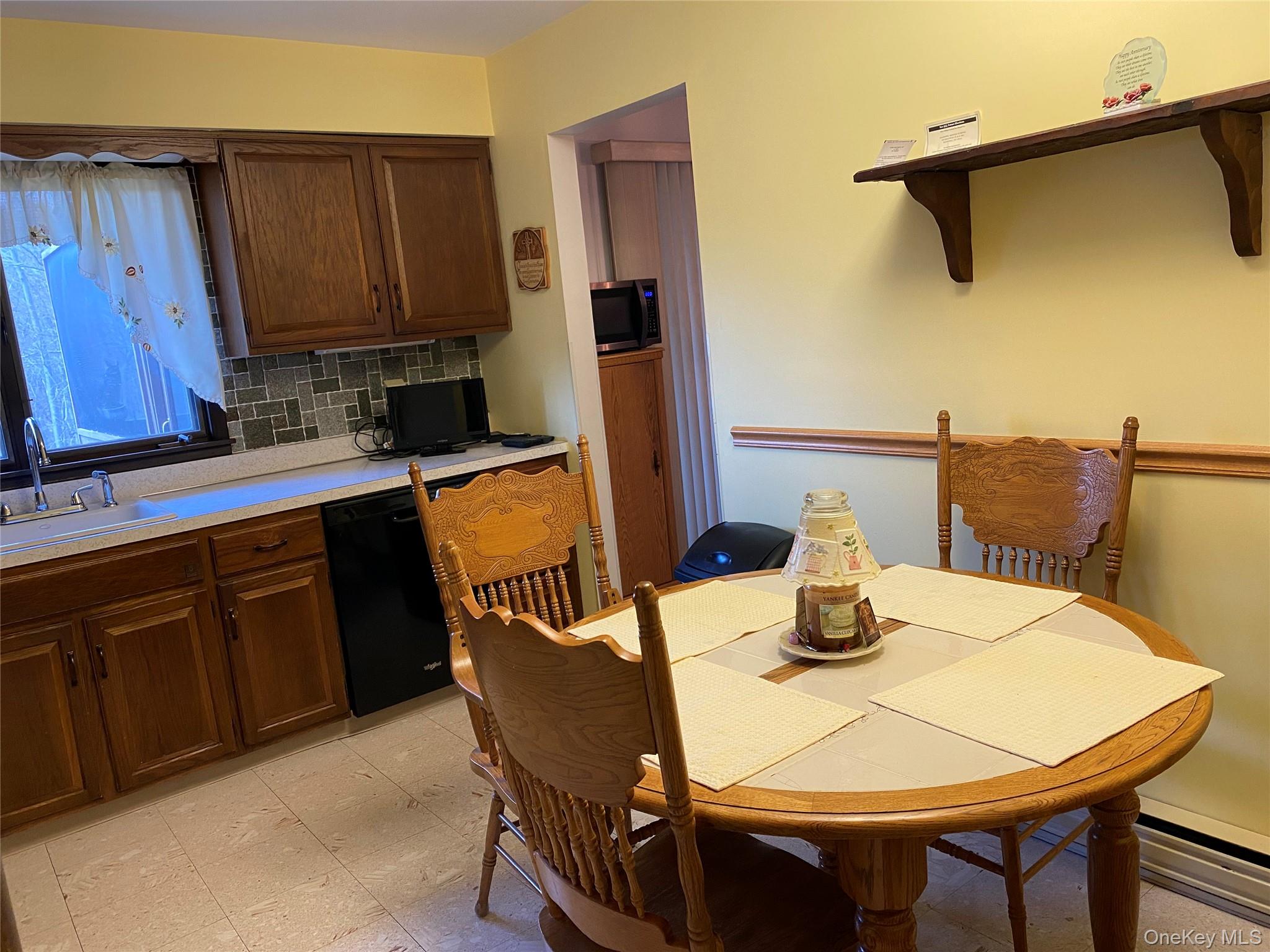23 Colton Road Mahopac, NY 10541 - Photo 23 of 35 The kitchen features wood cabinetry, a tiled backsplash, and a built-in dishwasher