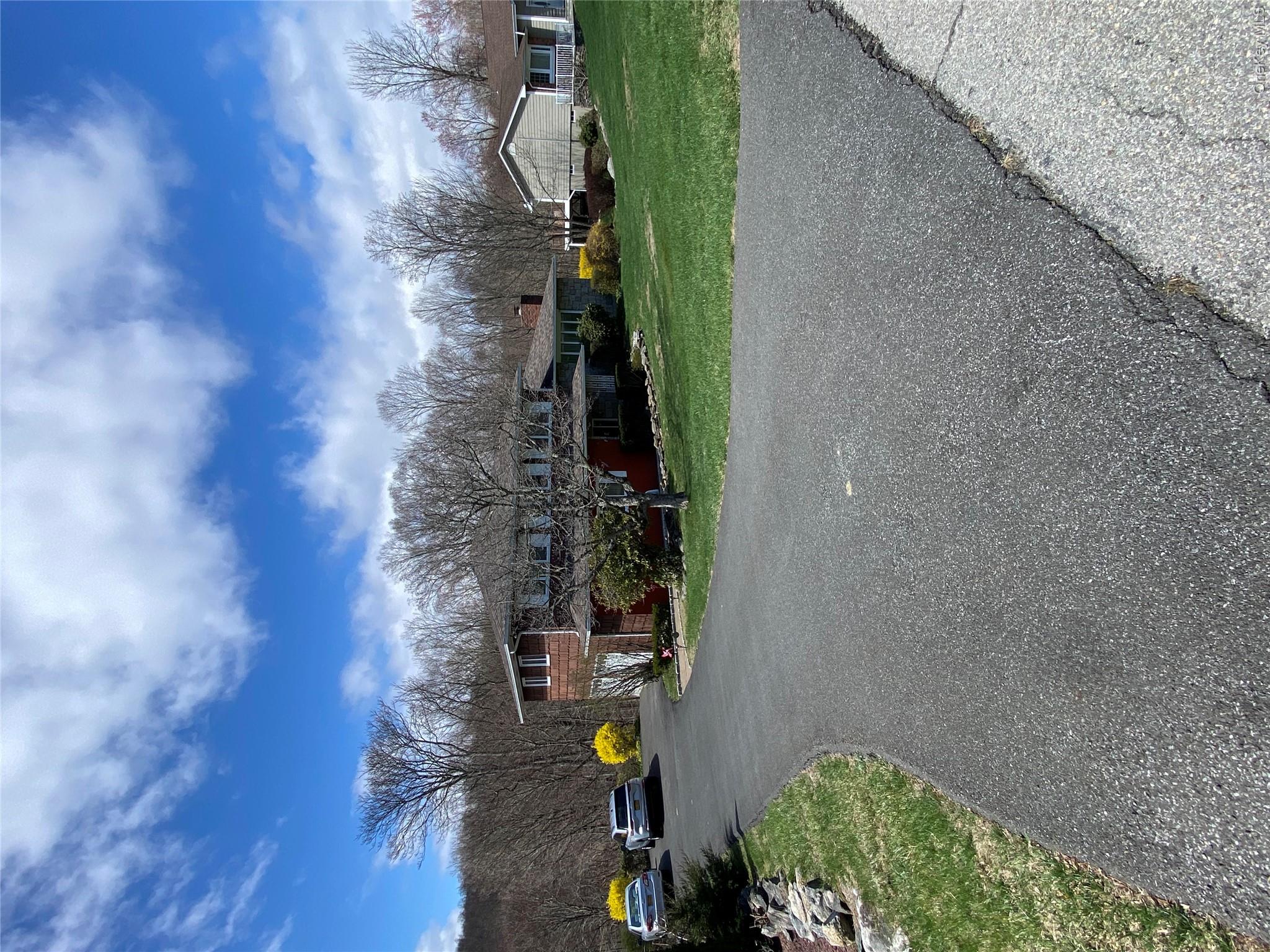 23 Colton Road Mahopac, NY 10541 - Photo 3 of 35 The property features a spacious driveway and a well-maintained lawn