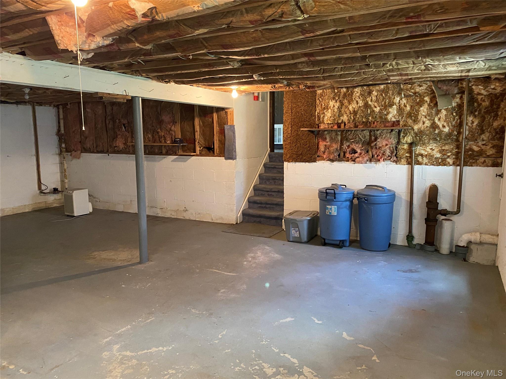 23 Colton Road Mahopac, NY 10541 - Photo 34 of 35 Spacious lower level offering concrete flooring, exposed ceiling joists, and a partial staircase