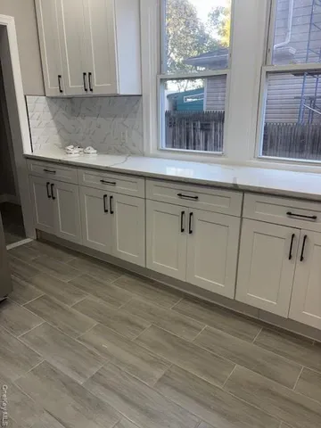 a view of a kitchen with granite countertop cabinets appliances and a window