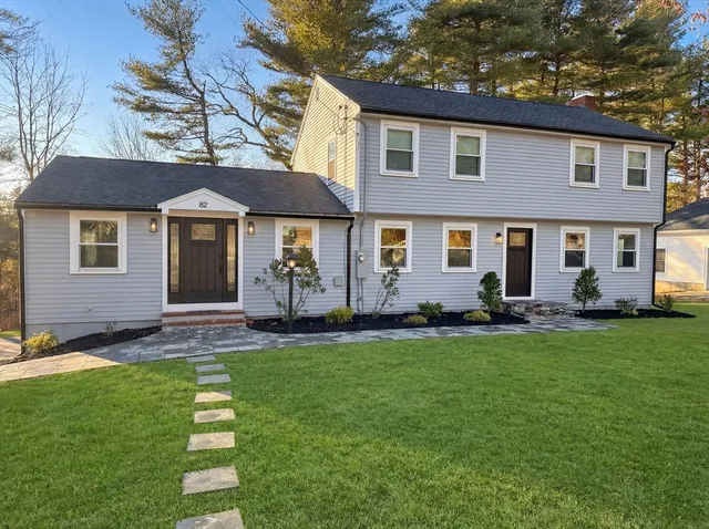 a front view of a house with a garden