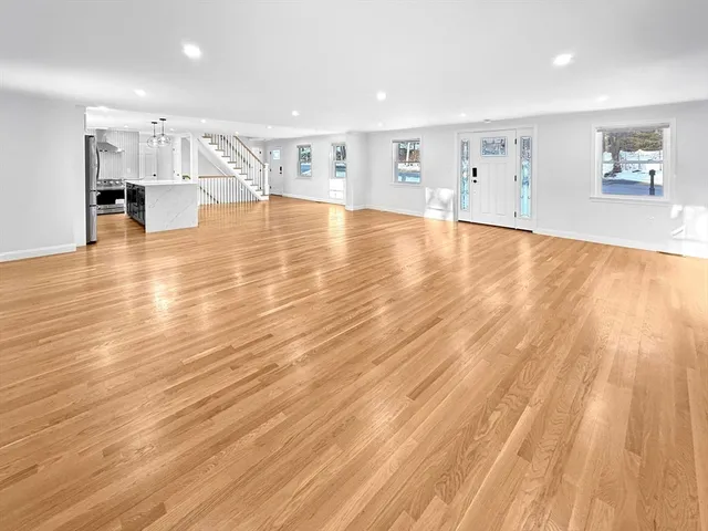 a view of a kitchen with wooden floor and a window