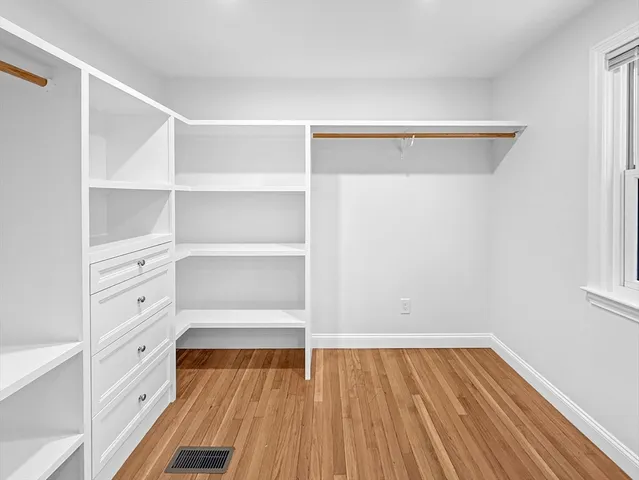 a view of walk in closet with empty racks