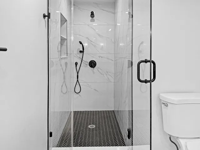 a bathroom with a glass shower door