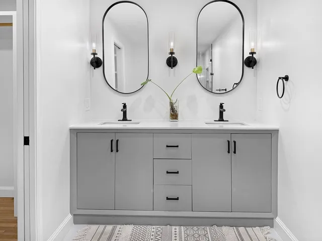 a bathroom with 2 sink and a mirror