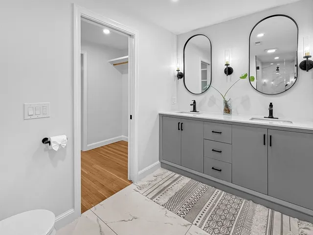 a bathroom with 2 sink and a mirror