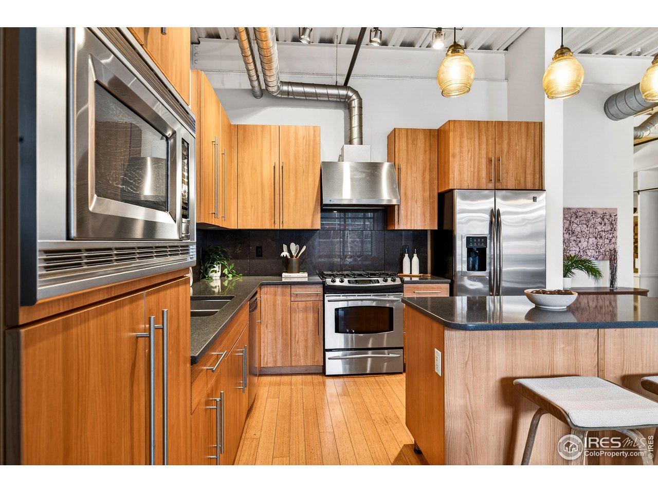 1360 Walnut Street, Unit 202 Boulder, CO 80302 - Photo 19 of 50 a kitchen with stainless steel appliances granite countertop a stove a sink and a microwave