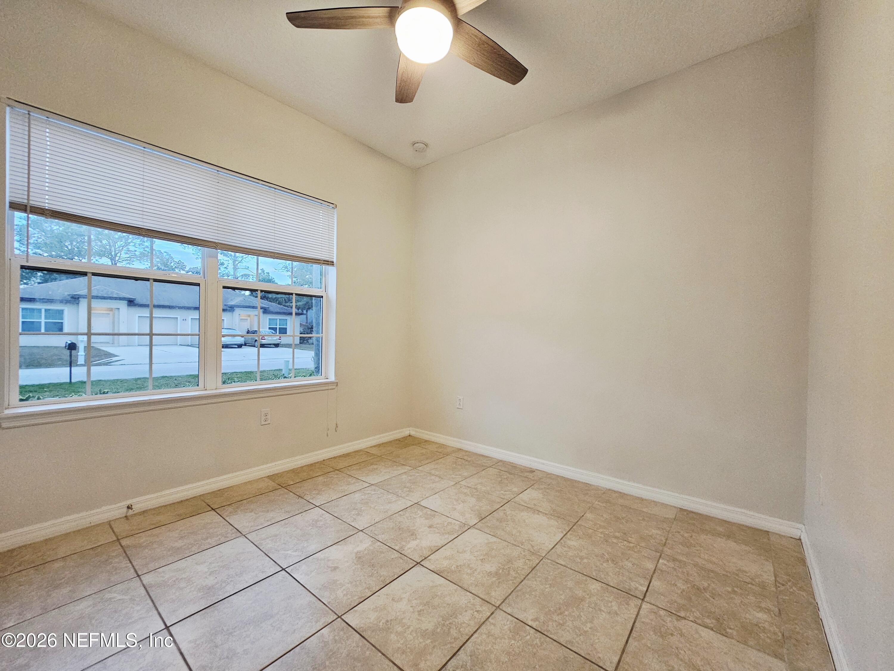 44 Prosperity Lane, Unit A Palm Coast, FL 32164 - Photo 6 of 9 an empty room with windows