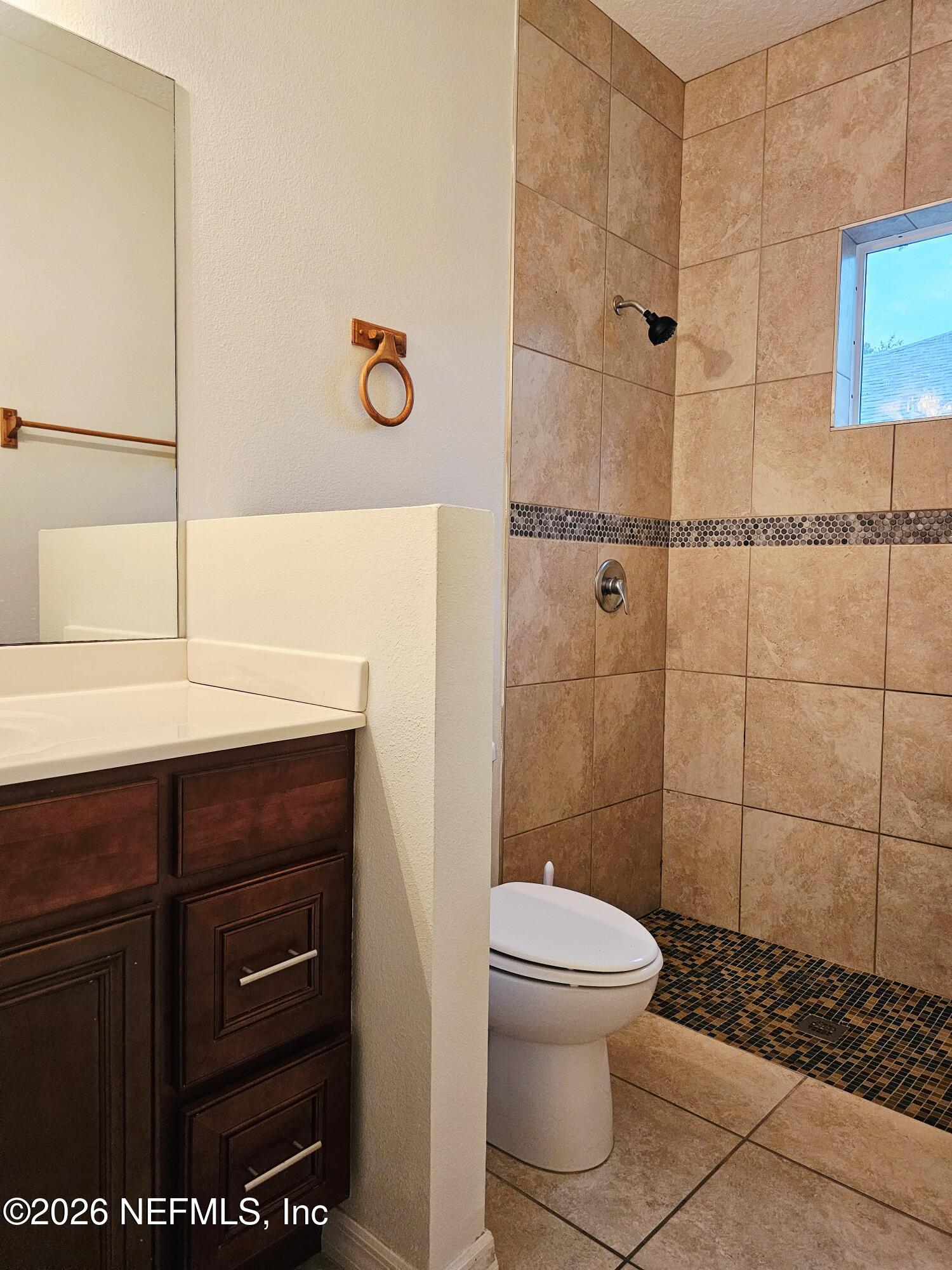 44 Prosperity Lane, Unit A Palm Coast, FL 32164 - Photo 7 of 9 a bathroom with a toilet a sink and shower