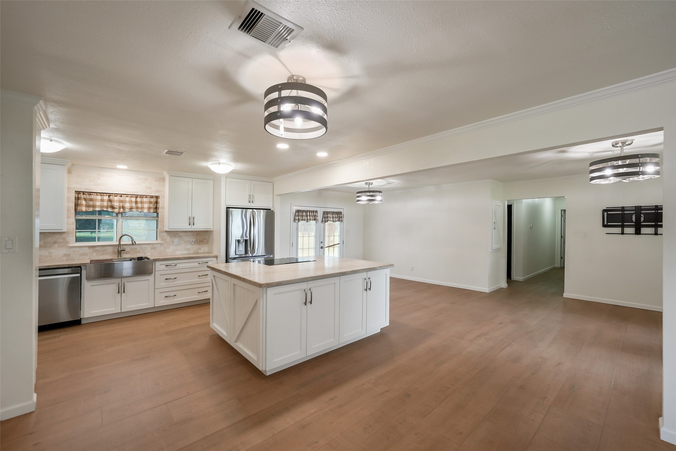 19635 Kermier Road Waller, TX 77484 - Photo 8 of 27 Bright, open living room with durable flooring and a spacious layout connected to the kitchen and dining areas.