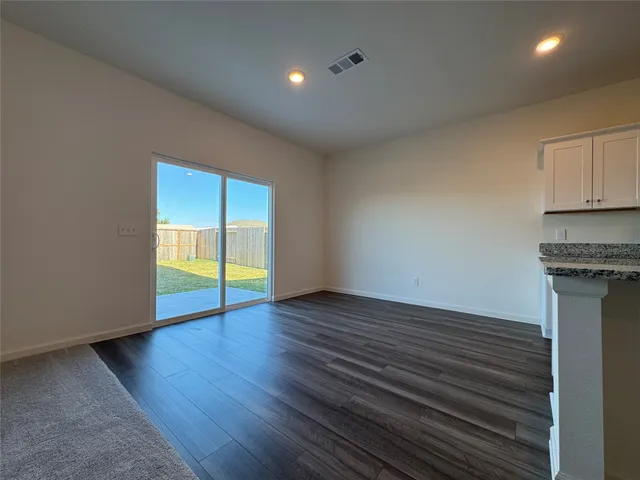 a view of a dining room with furniture and window