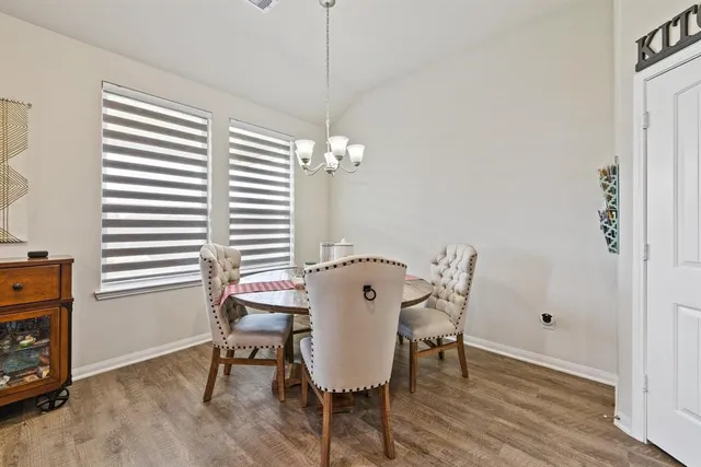 a view of a room with a table and chairs