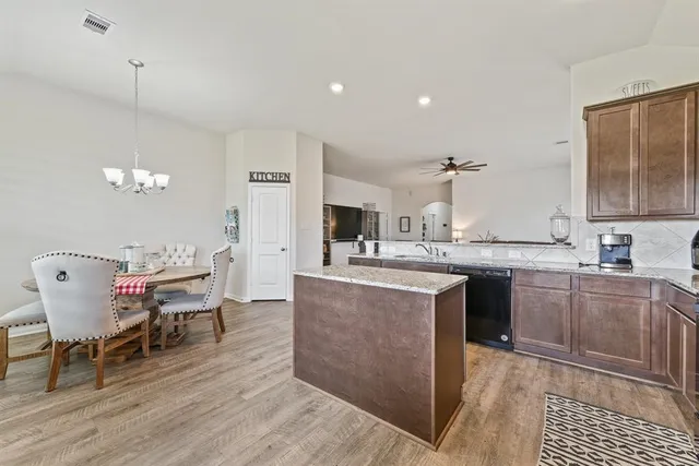 a kitchen with a table and chairs in it