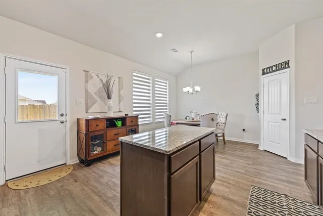a kitchen with stainless steel appliances granite countertop a stove and a refrigerator