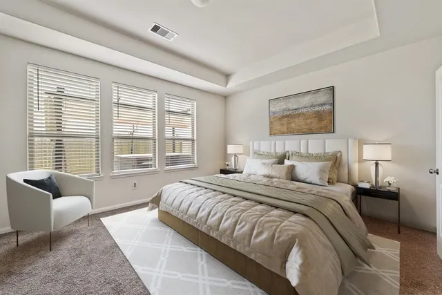 a bedroom with a bed couch and window