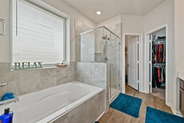 a bathroom with a tub and a shower