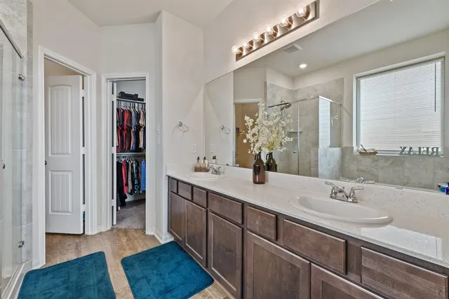 a bathroom with a sink double vanity and a mirror