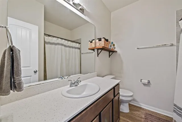 a bathroom with a sink toilet and shower