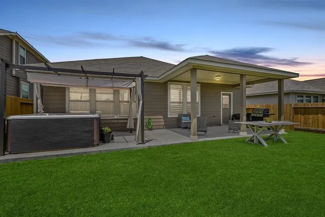 a view of an house with backyard porch and sitting area