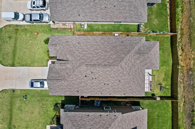 an aerial view of a house with a yard
