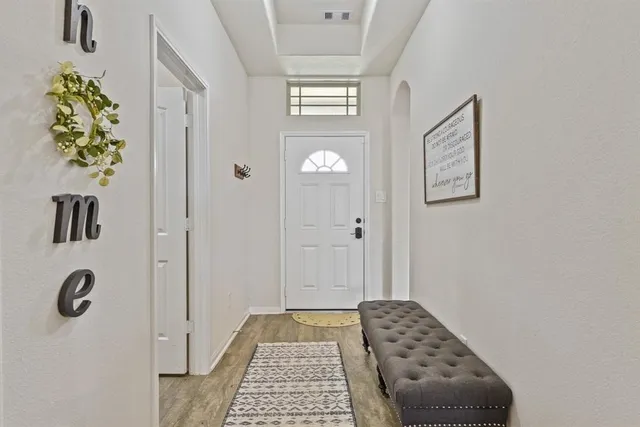 a walk in closet with window and a table