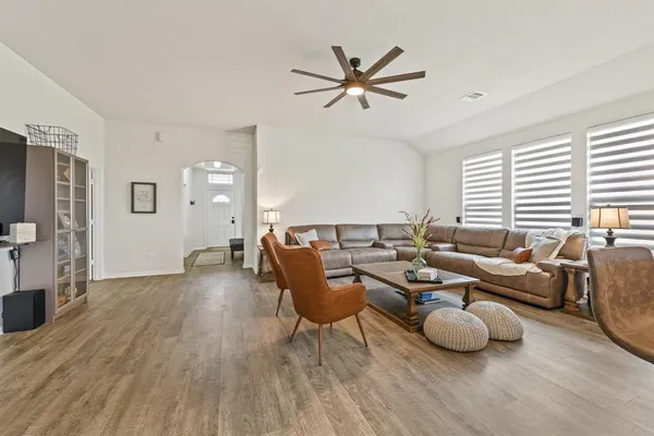 a living room with furniture and wooden floor