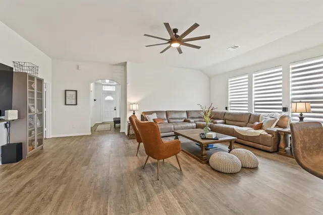 a living room with furniture and wooden floor