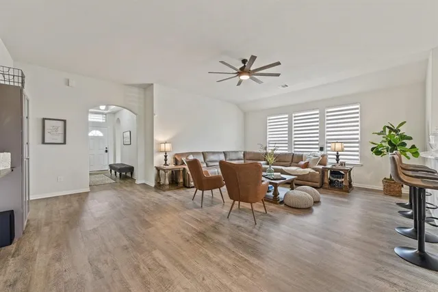 a living room with furniture window and wooden floor